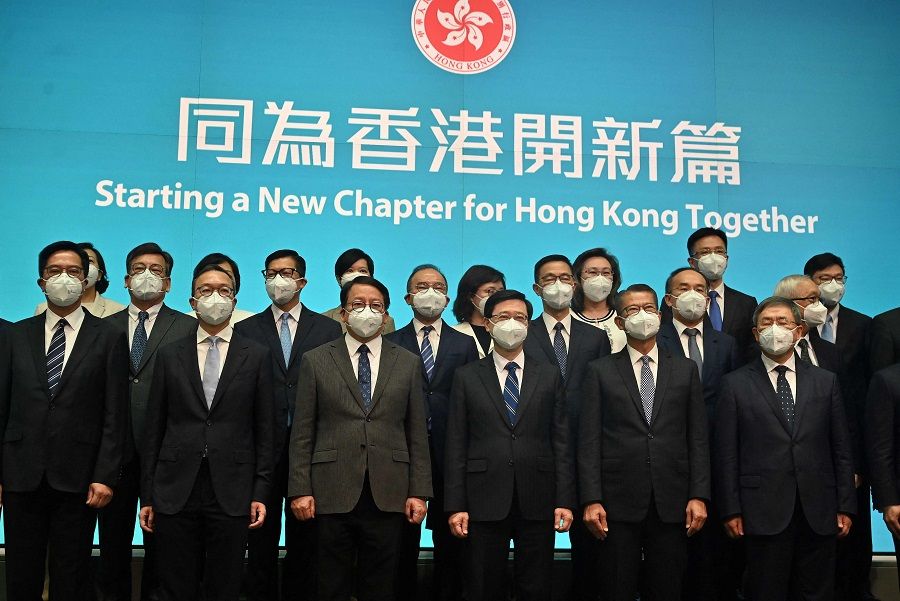 Hong Kong's leader-in-waiting John Lee (front, third from right) poses for a photo with his newly appointed cabinet at the central government headquarters in Hong Kong on 19 June 2022. (Peter Parks/AFP)