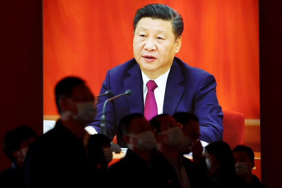 Visitors stand in front of an image of Chinese President Xi Jinping, at an exhibition titled "Forging Ahead in the New Era" during an organised media tour ahead of the 20th Party Congress of the Communist Party of China, in Beijing, China, 12 October 2022. (Florence Lo/Reuters)