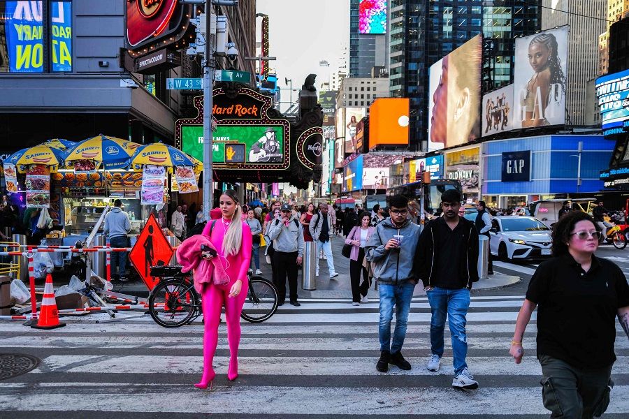 People make their way through Times Square in the Manhattan borough of New York, US, on 1 May 2024. (Charly Triballeau/AFP)
