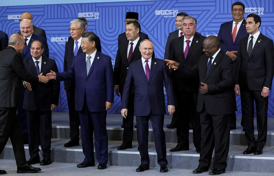 Russian President Vladimir Putin and participants in the outreach/BRICS Plus format meeting pose for a photo during the BRICS summit in Kazan, Russia, on 24 October 2024. (Maxim Shipenkov/Pool via Reuters)