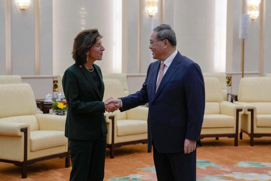 China's Premier Li Qiang (right) greets US Commerce Secretary Gina Raimondo at the Great Hall of the People in Beijing on 29 August 2023. (Andy Wong/AFP)