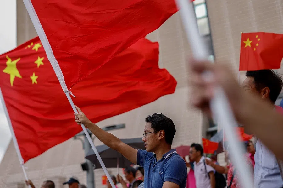 Pro-China supporters hold Chinese flags at an event celebrating the 27th anniversary of the former British colony’s handover to Chinese rule in Hong Kong, China, on 1 July 2024. (Tyrone Siu/Reuters)