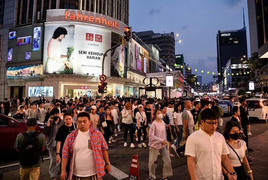 People walking on the streets of Bukit Bintang in Kuala Lumpur, Malaysia.