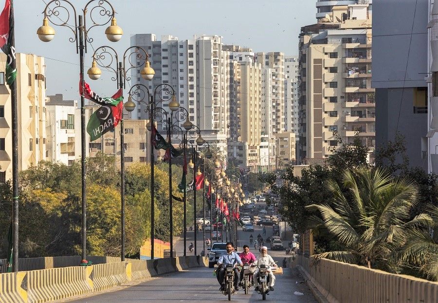 Traffic moves past apartment buildings in the Clifton area of Karachi, Pakistan, on 5 March 2022. (Asim Hafeez/Bloomberg)
