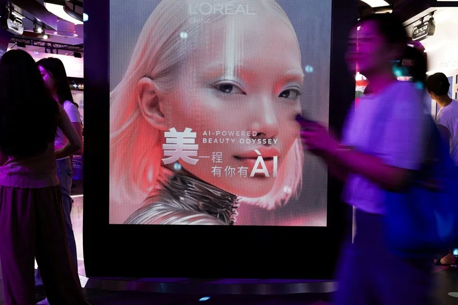 People walk past the L’Oreal booth during the World Artificial Intelligence Conference (WAIC) in Shanghai, China, on 17 July 2026.