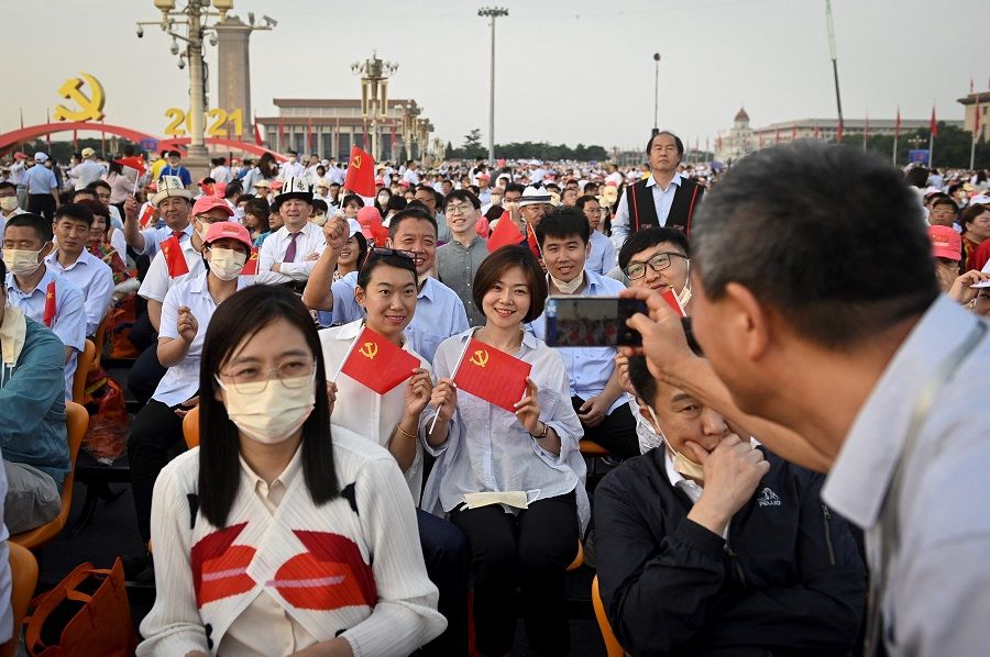 People pose for a picture before the celebration parade in Beijing, China, on 1 July 2021, to mark the 100th anniversary of the founding of the Communist Party of China. (Wang Zhao/AFP)