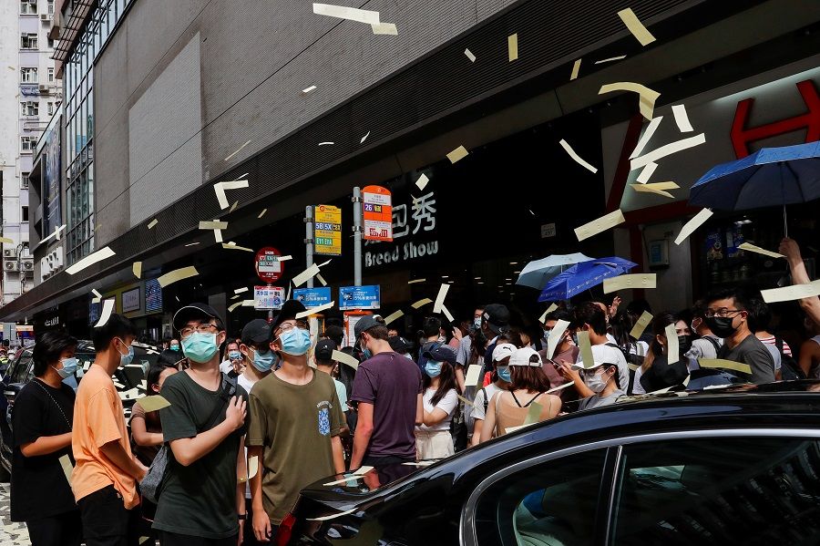 Anti-national security law protesters throw mock paper money during a march against national security law on the anniversary of Hong Kong's handover to China from Britain, in Hong Kong, China, 1 July 2020. (Tyrone Siu/Reuters)