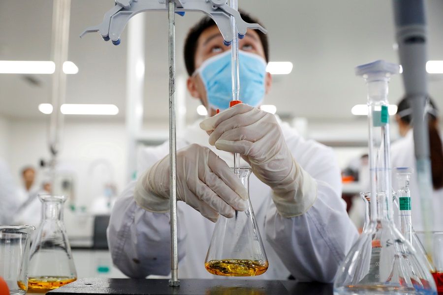 A man works in a laboratory of Chinese vaccine maker Sinovac Biotech, developing an experimental Covid-19 vaccine, Beijing, China, 24 September 2020. (Thomas Peter/File Photo/Reuters)