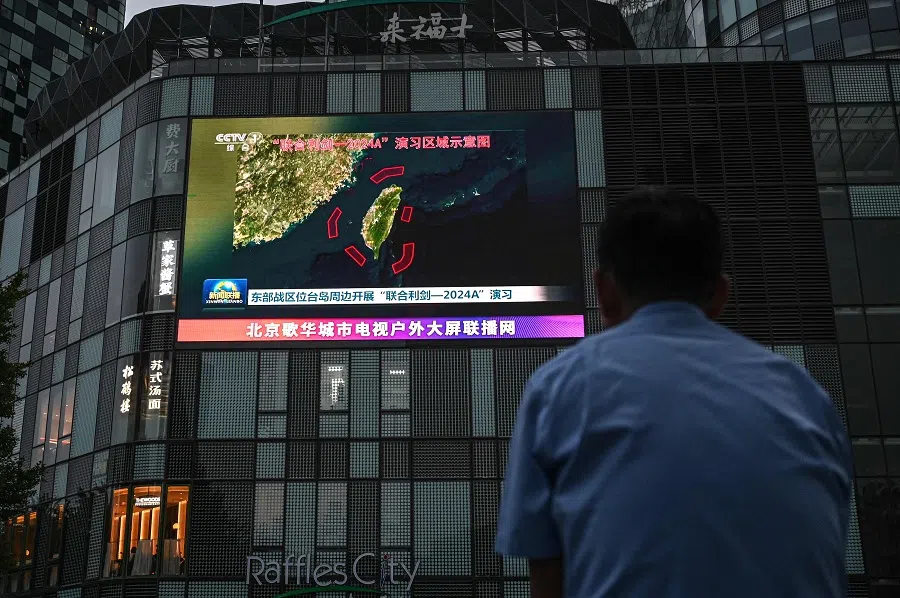 An outdoor screen shows news coverage of China’s military drills around Taiwan, in Beijing, China, on 23 May 2024. (Jade Gao/AFP)