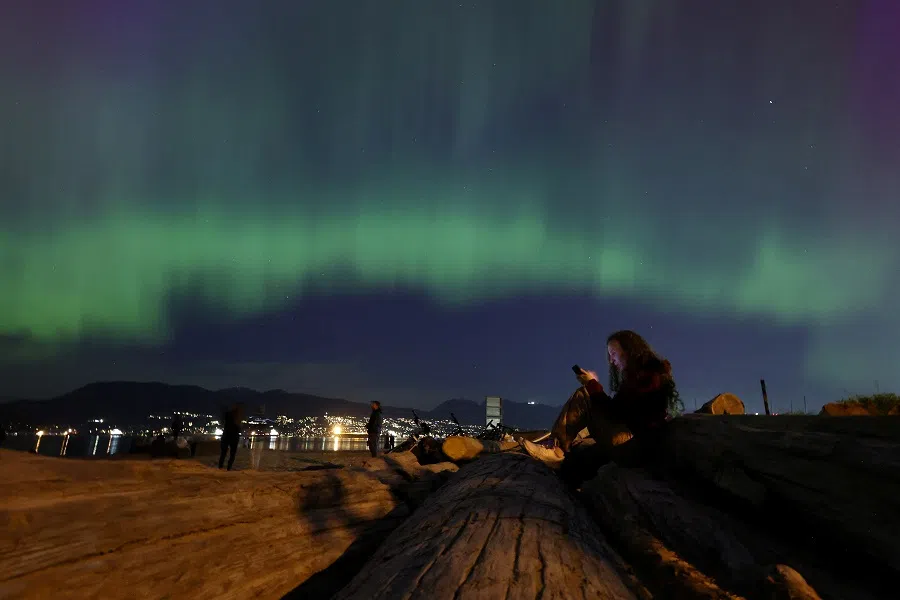 The aurora borealis, also known as the “northern lights”, illuminates the sky over Jericho Beach in Vancouver, British Columbia, Canada, on 10 May 2024. (Chris Helgren/Reuters)