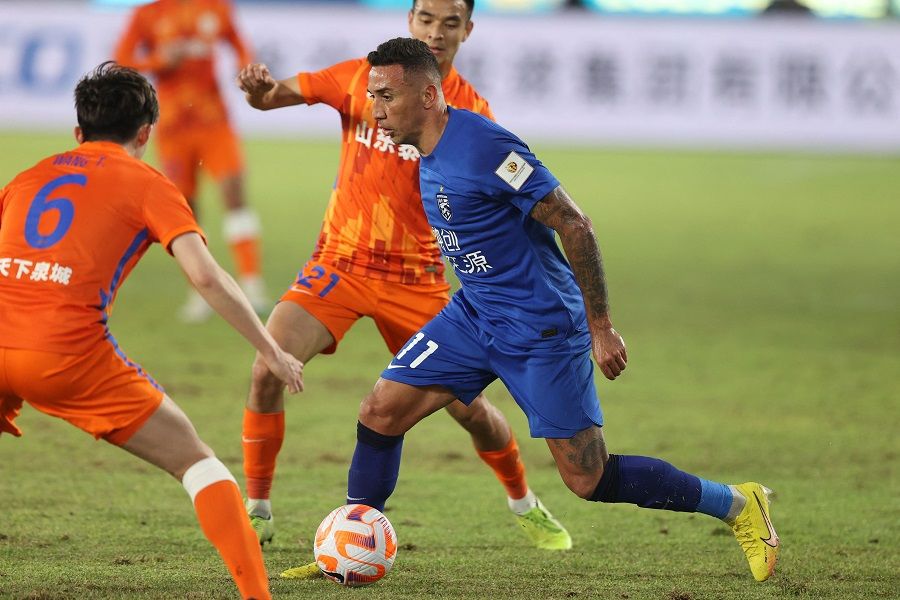 Wuhan Three Towns' Davidson da Luz Pereira (right) fights for the ball during their 2023 Chinese Football Association (CFA) Supercup football match with Shandong Taishan FC in Hangzhou, Zhejiang province, China, on 8 April 2023. (AFP)