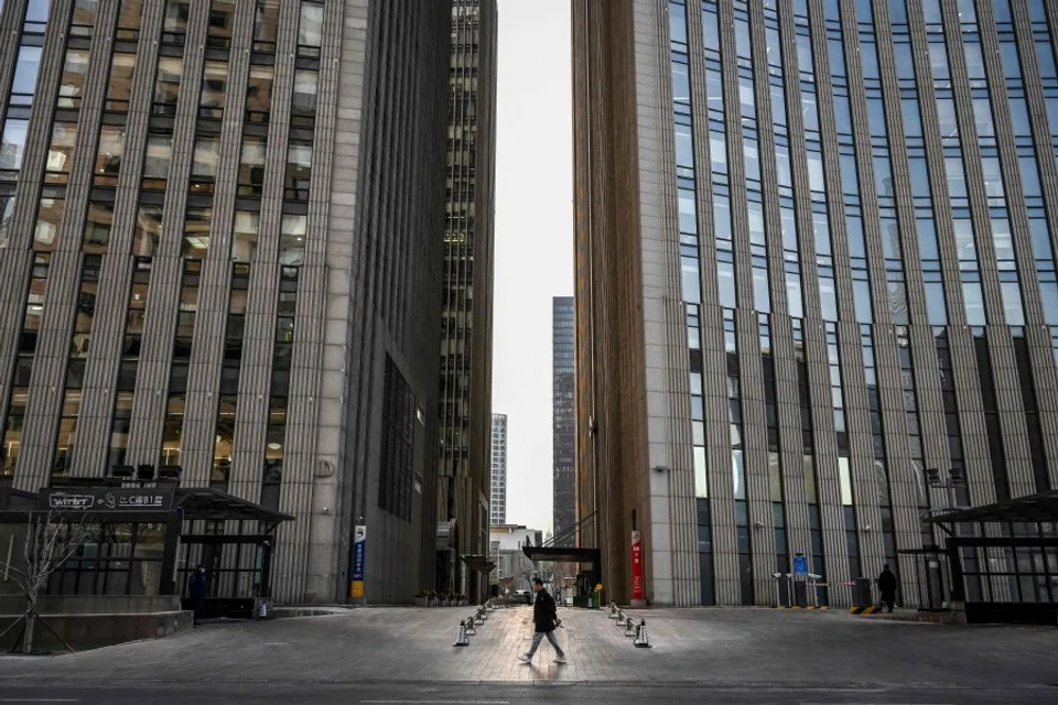 A man walks along a street in the central business district in Beijing on 3 February 2023. (Jade Gao/AFP)