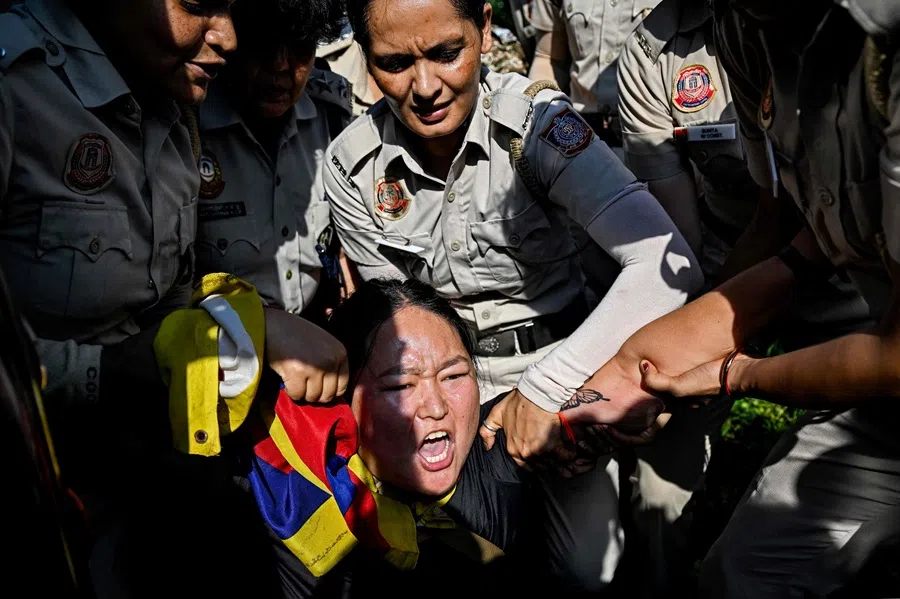 Police personnel detain a Tibetan protester near the Chinese embassy during a demonstration on the sidelines of China’s Foreign Minister Wang Yi’s visit to New Delhi on 18 August 2025. (Sajjad Hussain/AFP)