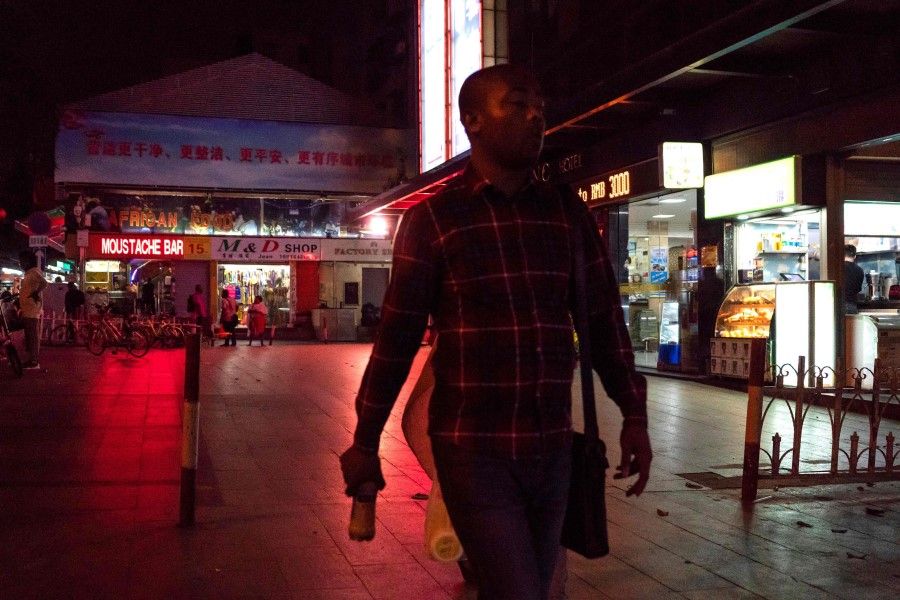 A man walks in the "Little Africa" district, Guangzhou, March 2, 2018. (Fred Dufour/AFP)