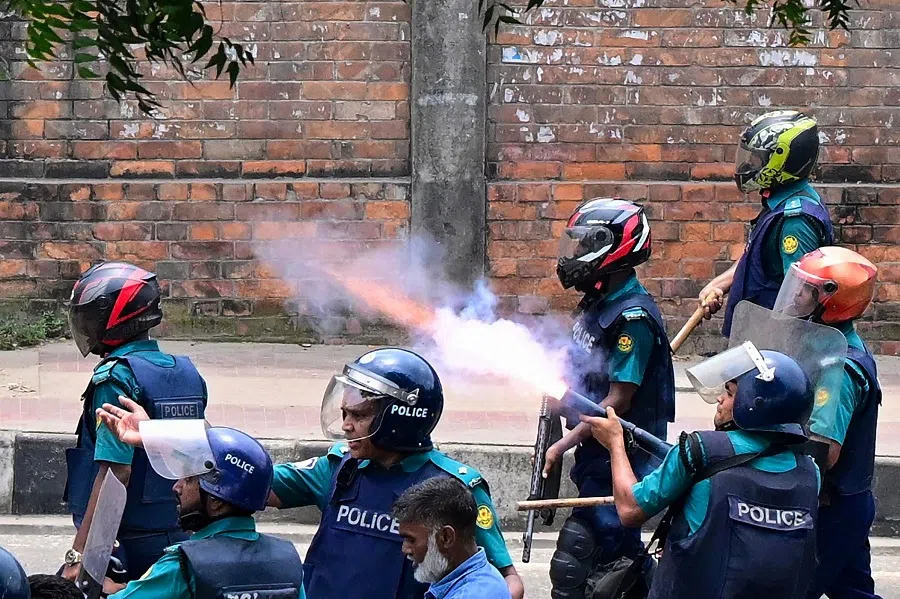 Bangladesh police fire tear shells to disperse anti-quota protesters during a clash in Dhaka on 18 July 2024. (Munir Uz Zaman/AFP)