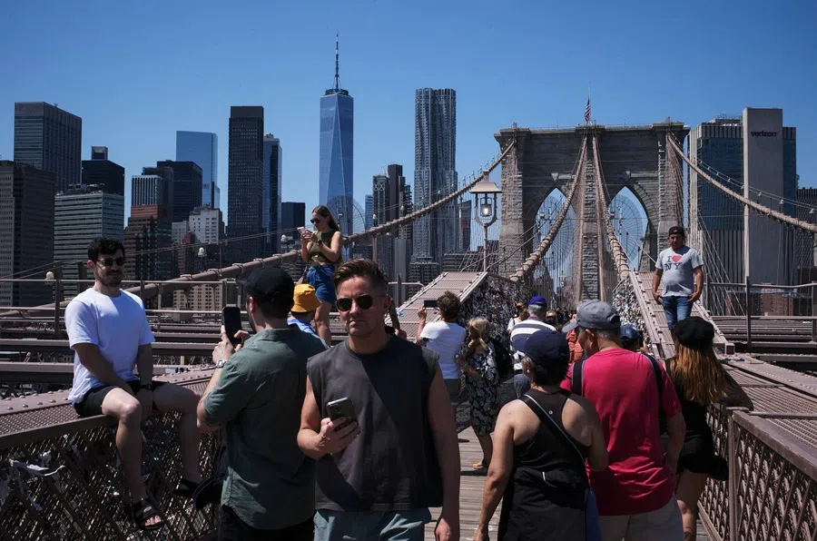 People walk on Brooklyn Bridge in New York City, US, on 8 August 2025. (Adam Gray/Reuters)