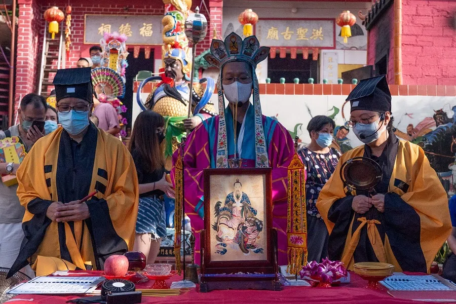 Priests chant scriptures during a ceremony at a temple in Hong Kong on 21 August 2021, marking the Hungry Ghost Festival. (Bertha Wang/AFP)