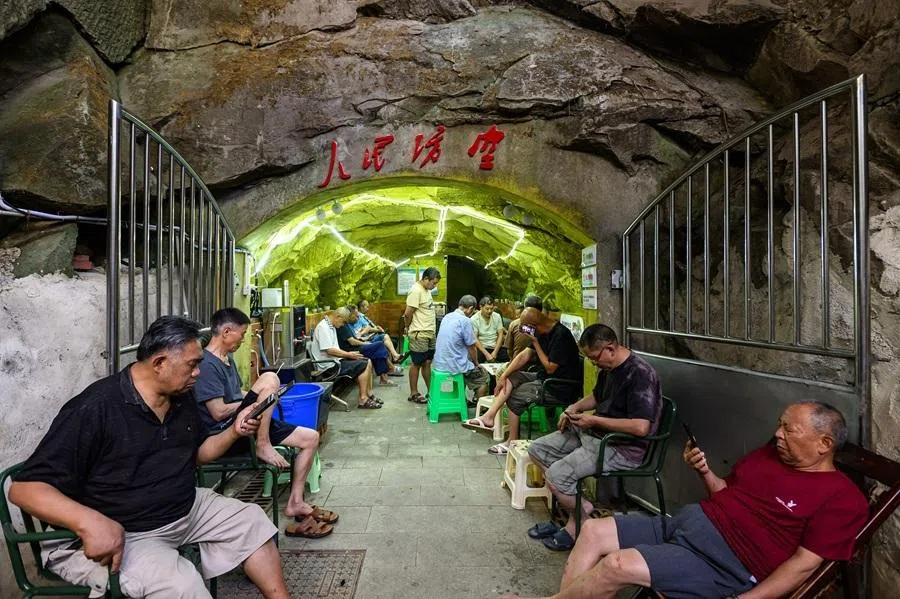On 16 July 2026, Chongqing residents sought respite from the heat in an air-raid shelter in Shapingba district.