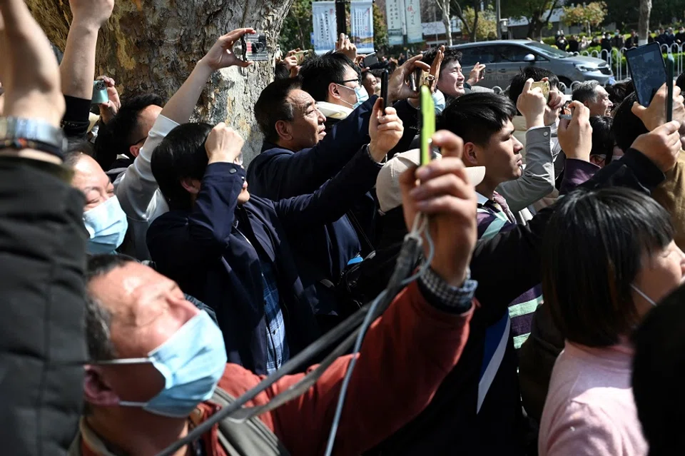 People wave as the motorcade of former Taiwan president Ma Ying-jeou arrives at the Museum of Modern Chinese History in Nanjing, Jiangsu province, China, on 28 March 2023. (Greg Baker/AFP)