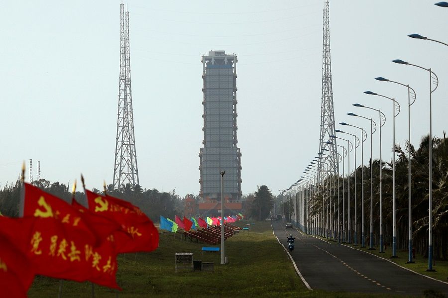 Flags with Chinese Communist Party's emblem flutter along a road leading to a launch tower with the Long March-5 Y5 rocket inside before its launch, at Wenchang Space Launch Center in Hainan Province, China, 23 November 2020. (Tingshu Wang/Reuters)