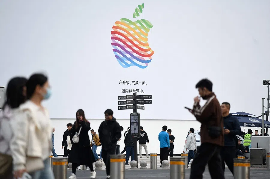 People walk past an Apple Store along a shopping street in Beijing on 8 April 2025. (Wang Zhao/AFP)