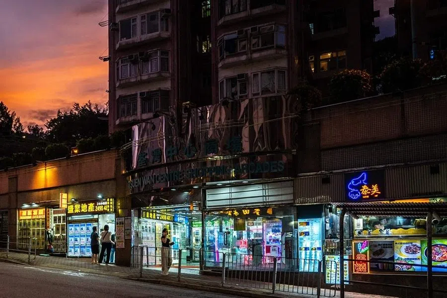 This picture taken on 9 June 2026 shows people gathering in front of the entrance to a housing estate's shopping arcade in Hong Kong's Tsuen Wan district in the New Territories.