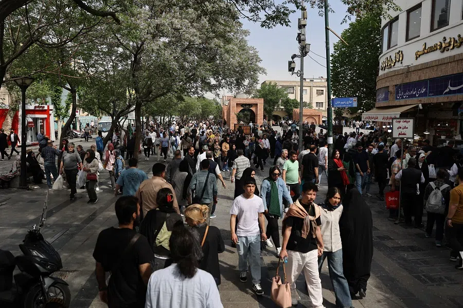 People walk at the Tehran Bazaar in Tehran, Iran, 14 April 2025.  (Majid Asgaripour/WANA (West Asia News Agency) via Reuters)