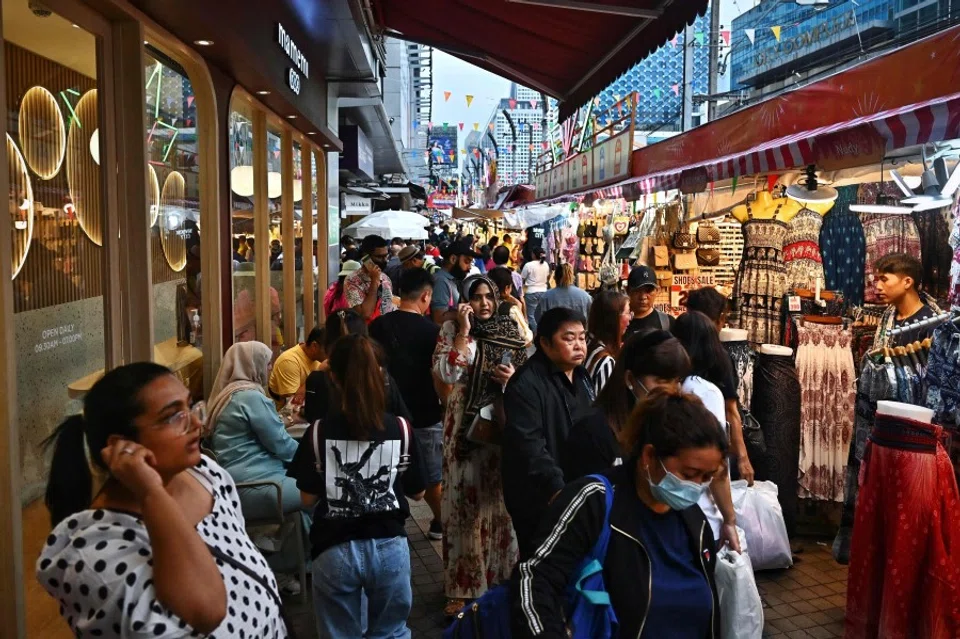 Tourists navigate an open air market in Bangkok on 16 October 2023. (Lillian Suwanrumpha/AFP)