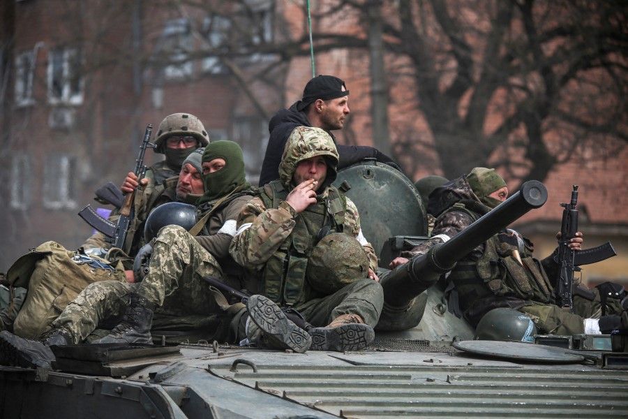 Service members of pro-Russian troops are seen atop an armoured vehicle during the Russia-Ukraine conflict in the southern port city of Mariupol, Ukraine, 21 April 2022. (Chingis Kondarov/Reuters)
