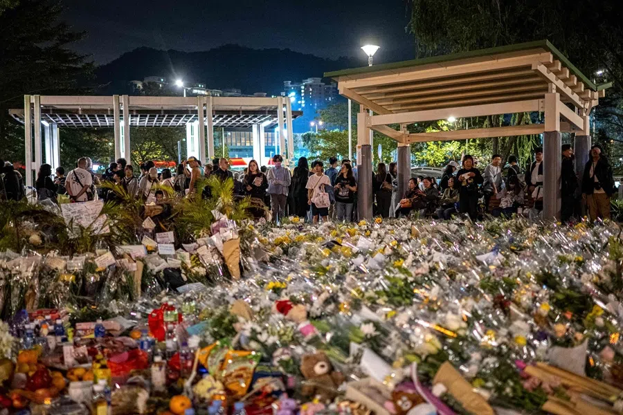 People offer flowers for the victims outside the Wang Fuk Court in the aftermath of the deadly 26 November fire in Hong Kong's Tai Po district on 30 November 2025. (Philip Fong/AFP)