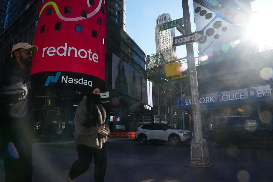 An advertisement for “RedNote,” a Chinese social media app, is seen as people walk by the Nasdaq headquarters in Times Square, on 27 January 2025 in New York City. (Bryan R. Smith/AFP)
