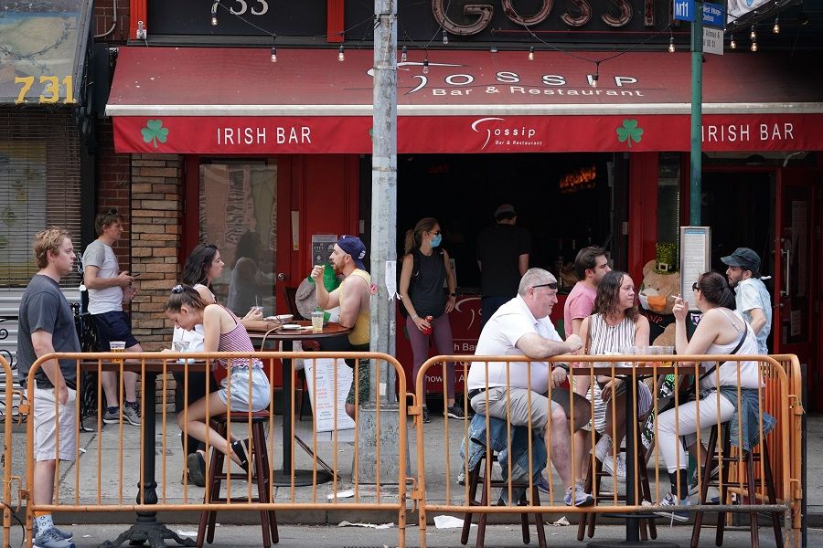 People drink outdoors at bars and restaurants in New York on 7 June 2020. (Bryan R. Smith/AFP)