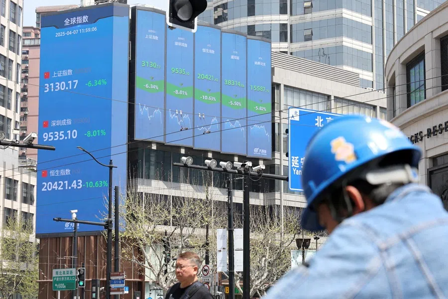 An electronic board shows Shanghai, Shenzhen, and Hang Seng stock indices in Shanghai, China, 7 April 2025. (Go Nakamura/Reuters)