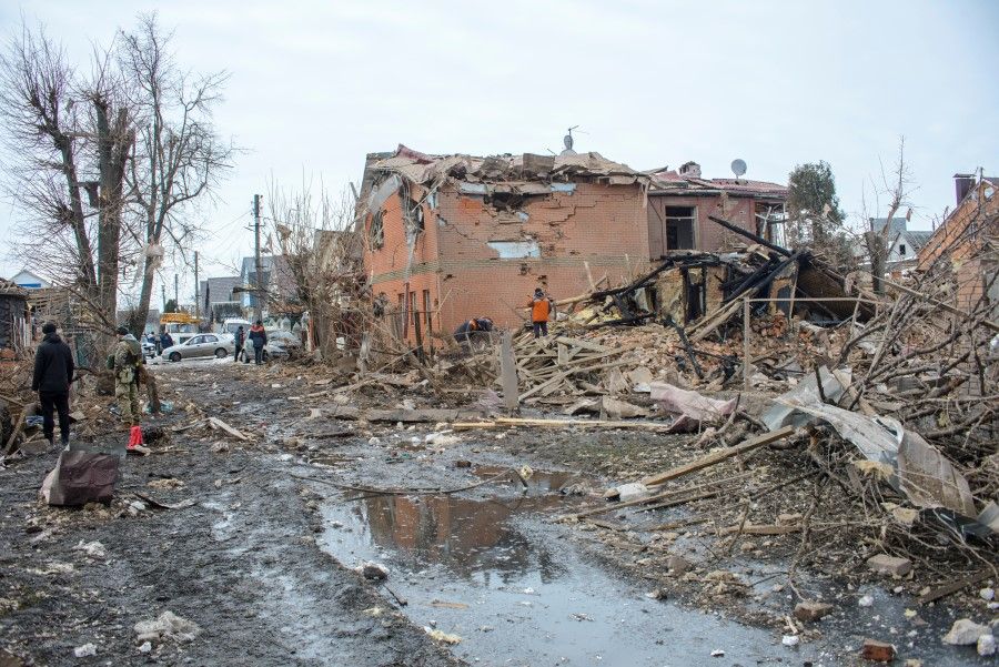 People search through debris near houses destroyed by shelling, amid Russia's invasion of Ukraine, in Sumy, Ukraine, 8 March 2022, in this picture obtained from social media. (Andrey Mozgovoy/via Reuters)