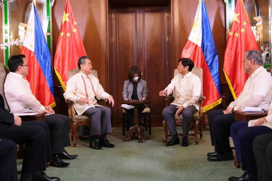 This handout photograph taken and received on 6 July 2022 from the Philippines' Presidential Photographers Division (PPD) shows Chinese State Councilor and Foreign Minister Wang Yi (2L) paying a courtesy call to Philippine President Ferdinand Marcos Jr. (2R) at Malacañang Palace in Manila. (Philippines' PPD/AFP)