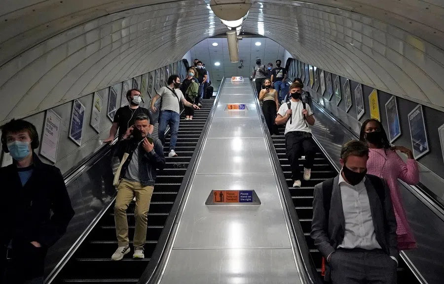 Commuters travel on an escalator in a Transport for London (TFL) underground train station in central London on 7 June 2021. (Niklas Halle'n/AFP)