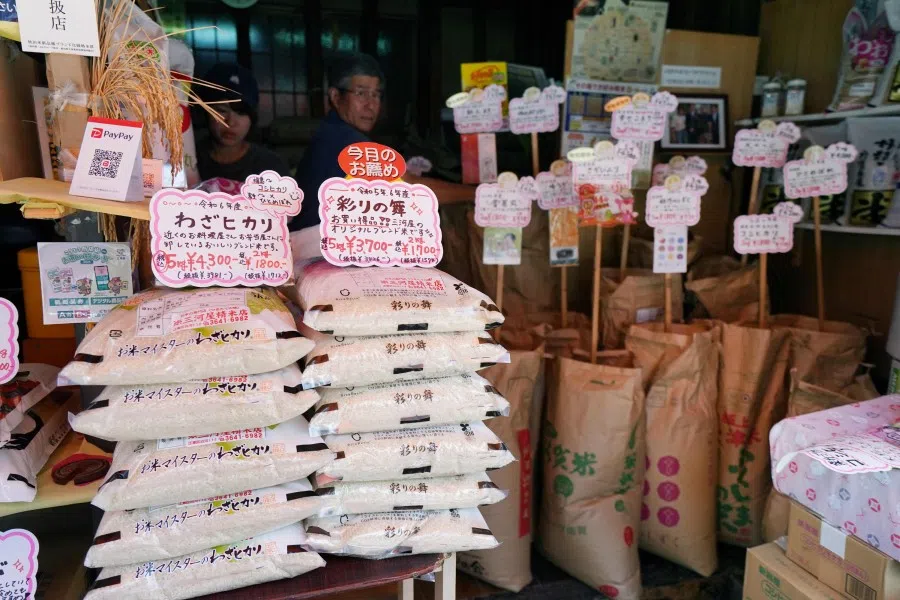 Bags of rice are seen at the entrance to a rice mill shop in line in Tokyo on 18 July 2025. (Kazuhiro Nogi/AFP)
