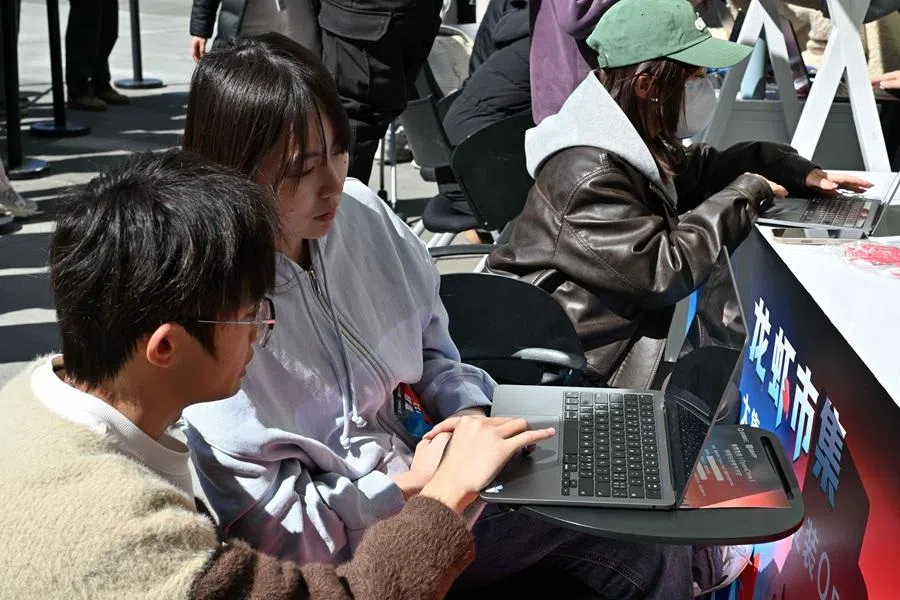An engineer sets up OpenClaw, an open-source AI assistant for a user at the Baidu headquarter in Beijing on 11 March 2026. (Adek Berry/AFP)