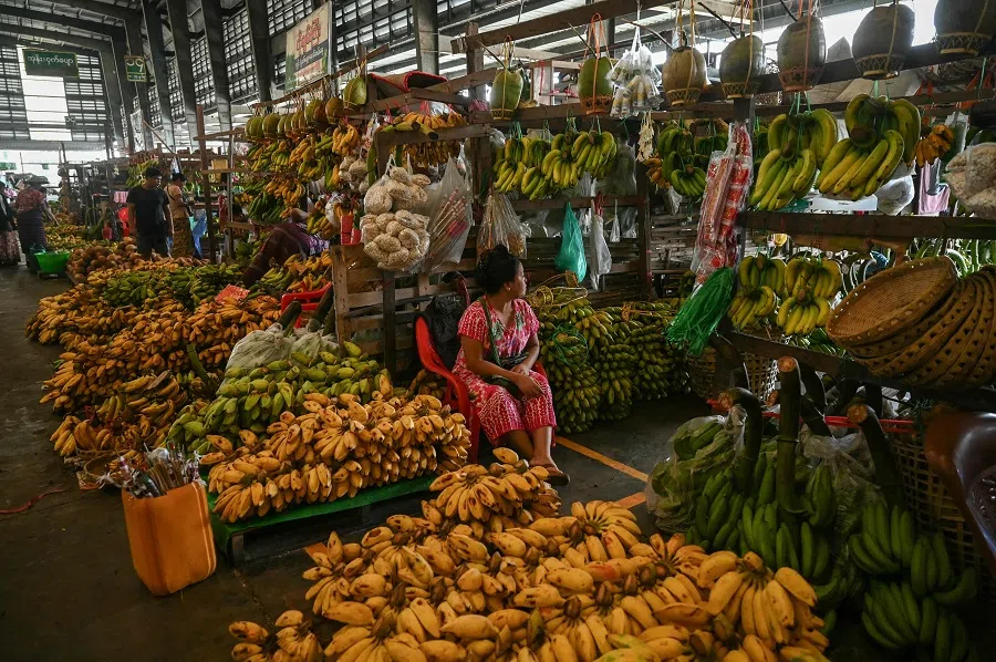 A vendor at the Da Nyin Gone vegetable wholesale market in Yangon, Myanmar, on 19 September 2023. (Sai Aung Main/AFP)