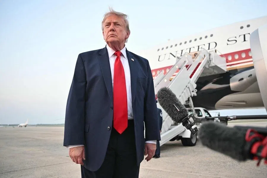 US President Donald Trump speaks to reporters after stepping off Air Force One upon returning to Joint Base Andrews in Maryland on 19 July 2026.