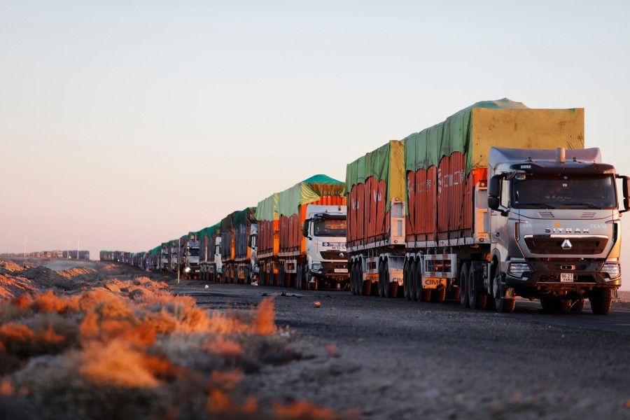 This picture taken on 16 October 2021 shows trucks loaded with coal waiting near Gants Mod port at the Chinese border with Gashuun Sukhait, in Umnugovi province, in Mongolia. (Uugansukh Byamba/AFP)