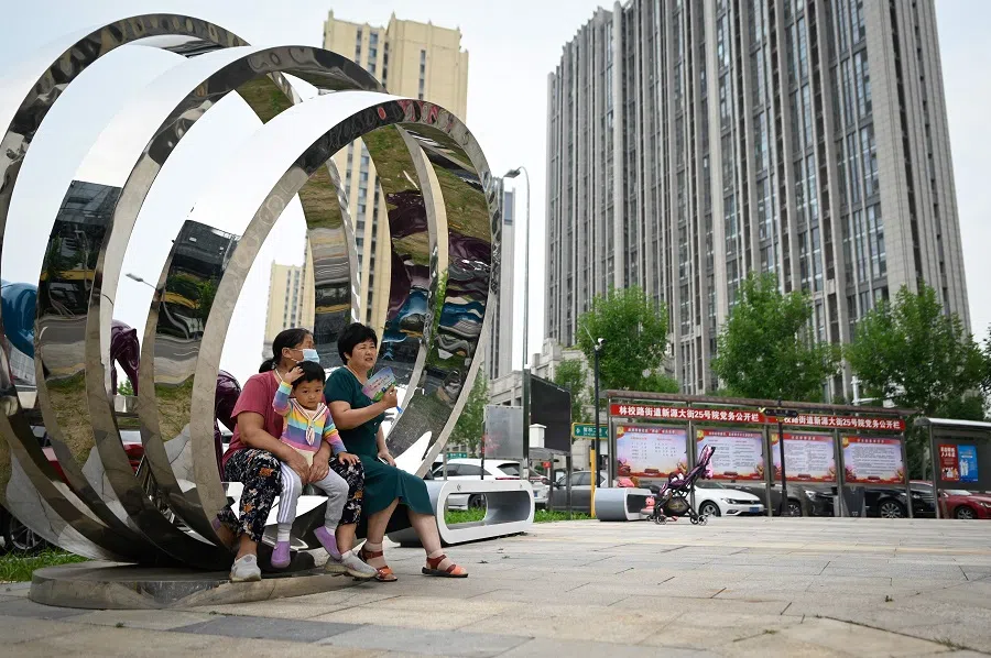 Two elderly women chat outside a residential area in Beijing, China, on 14 September 2021. (Wang Zhao/AFP)