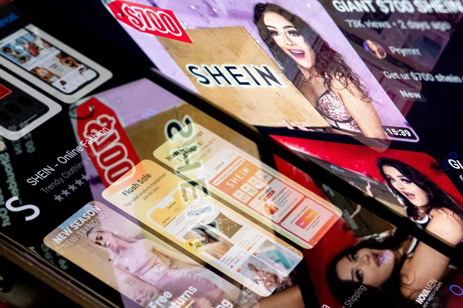 In this file illstration photo taken on 23 February 2023, the Shein app in the app store is reflected in videos of Shein consumers in Washington, DC, US. (Stefani Reynolds/AFP)
