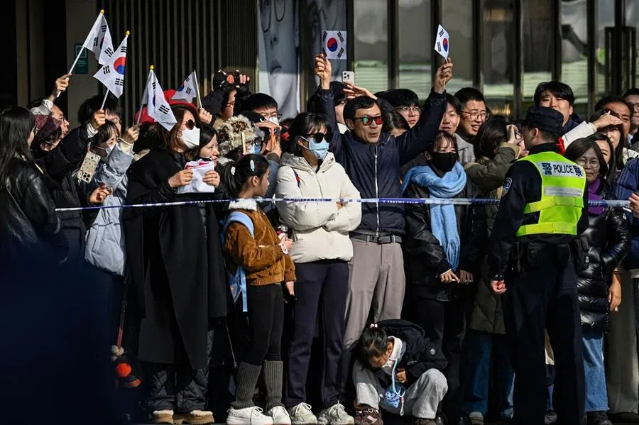 People raise flags of South Korea during South Korea’s President Lee Jae-myung’s visit to the former site of Korea’s provisional government, which served as the temporary government of Korea during Japan’s colonial rule, in Shanghai on 7 January 2026. (Jade Gao/AFP)