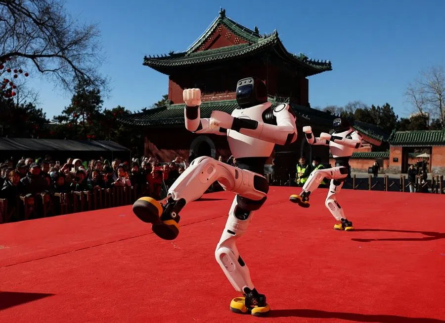 People watch as robots perform a dance during Lunar New Year celebrations in Beijing, China, on 18 February 2026. (Maxim Shemetov/Reuters)