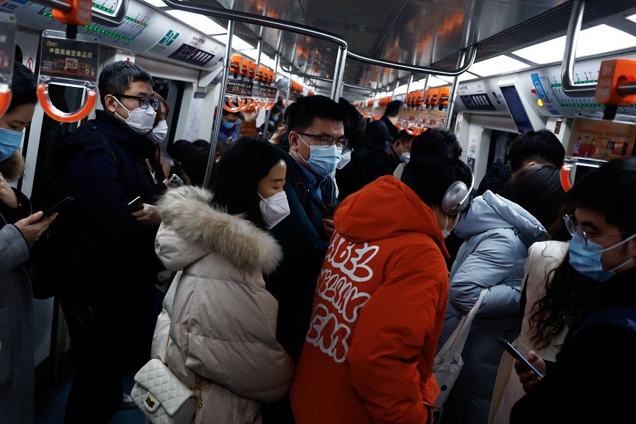 People ride on a subway during morning rush hour in Beijing, China, 30 January 2023. (Tingshu Wang/Reuters)