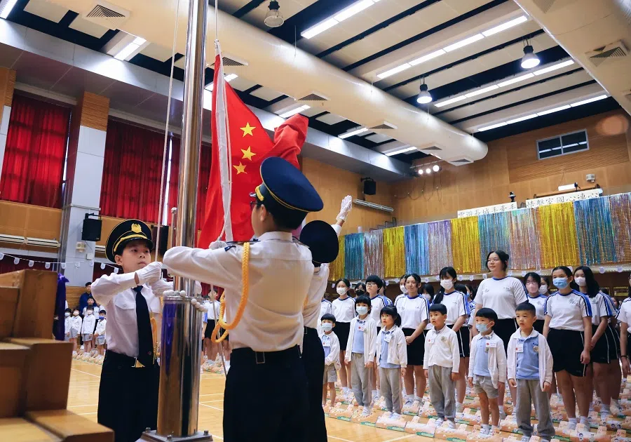 School students attend the flag-raising ceremony for World Reading Day on 23 April 2024, at Ho Ming Primary School, Hong Kong.
