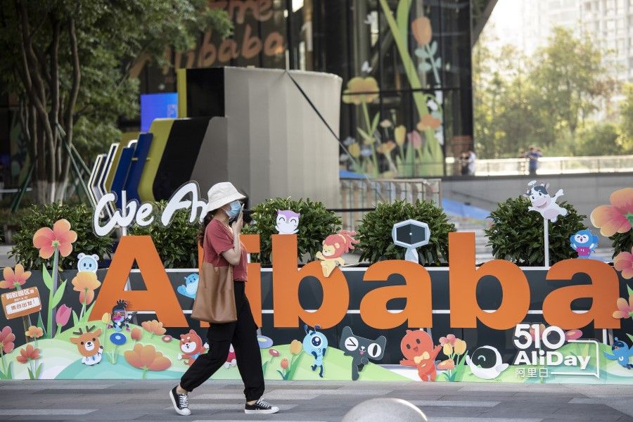 A person walks past a sign at the Alibaba Group Holding Ltd. headquarters in Hangzhou, China on 8 May 2021. (Qilai Shen/Bloomberg)