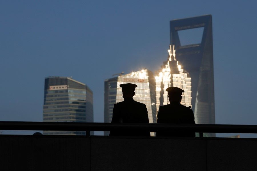 Paramilitary police officers stand guard at the Bund, in front of Lujiazui financial district of Pudong, on the day of the opening session of the Chinese People's Political Consultative Conference (CPPCC), in Shanghai, China, 4 March 2021. (Aly Song/Reuters)