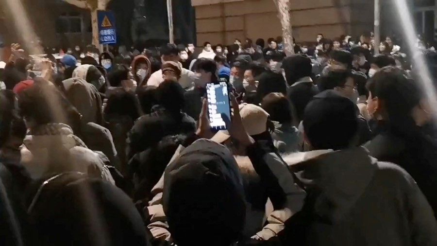Students protest at the Nanjing Tech University demanding to be allowed to go home after a student tested positive for coronavirus disease (Covid-19) in Nanjing, Jiangsu Province, China, in this screen grab obtained by Reuters on 6 December 2022. (Reuters)